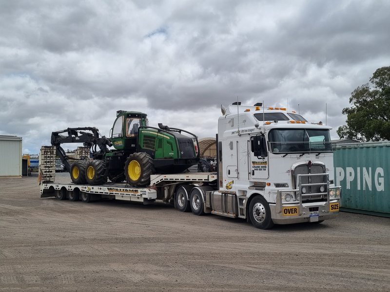 Kenworth K200 carrying an oversize forestry machine
